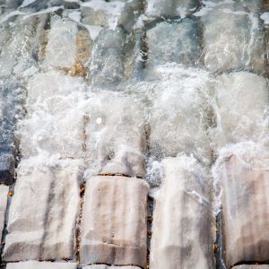 Seawater rolls up the blocks of stone